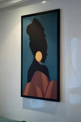 a framed picture of a woman on a wall at Racine Two bedroom flat near twin center in Casablanca