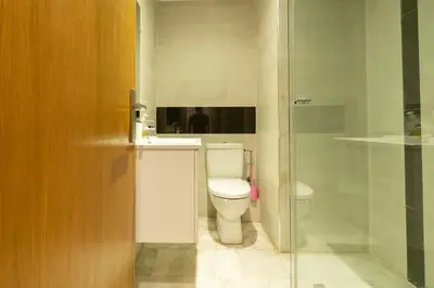 a bathroom with a toilet and a glass shower at Racine Two bedroom flat near twin center in Casablanca