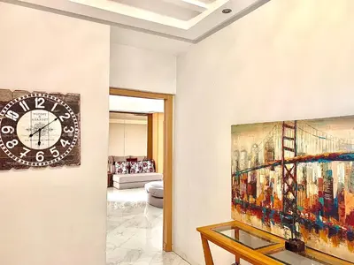a living room with a clock on the wall at Anfa 118 - Best view in town - 3 bedrooms - 2 Bathrooms in Casablanca