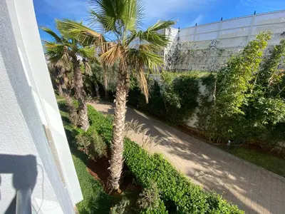 an aerial view of a palm tree next to a building at Très beau studio à Ain Diab in Casablanca