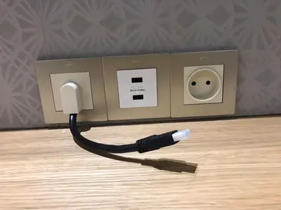 a black cord plugged into an electrical outlet at luxury apartment opposite HASSAN 2 MOSQU and FAIR international casablanca and SEA , near downtwn , INTERDIT COUPLES ARAABIC NON MARIÈ, FORBIDDEN UNMARRIED ARAABIC COUPLES , 2 room, 2 living rooms and 2 bathrooms basement car park FREE , apartment with in Casablanca
