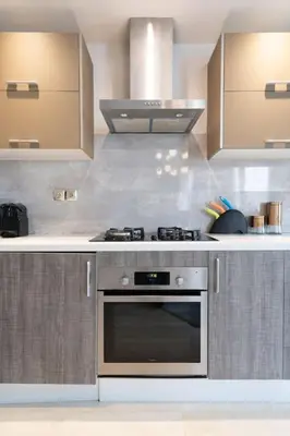 a kitchen with a stainless steel stove and cabinets at #56 Maarif Racine urban Massira near twin center in Casablanca