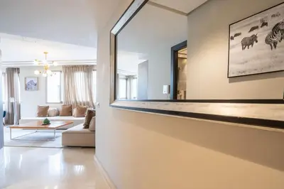 a living room with a large mirror on the wall at #56 Maarif Racine urban Massira near twin center in Casablanca