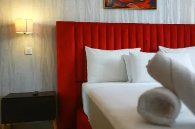 a hotel room with a bed with a red headboard at Racine appartement near twin center #heart of town in Casablanca