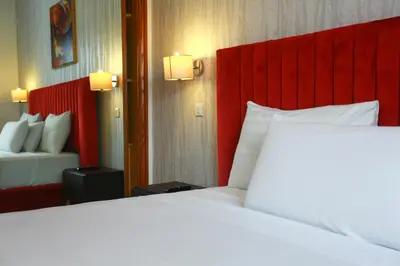 a bedroom with a large white bed and a red headboard at Racine appartement near twin center #heart of town in Casablanca