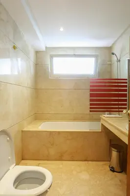 a bathroom with a toilet and a bath tub at Racine appartement near twin center #heart of town in Casablanca