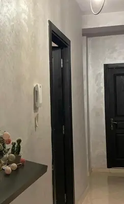a room with a door and a phone on the wall at Lovely 1-Bed Apartment in Skhirat in Skhirat