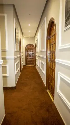 a hallway with wooden doors in a house at Hotel de paris in Casablanca