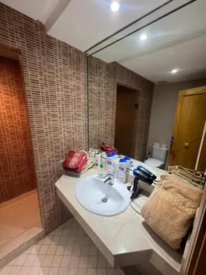 a bathroom with a sink and a mirror at PERLA NOUACEUR AéROPORT MOHAMMED V in Nouaceur