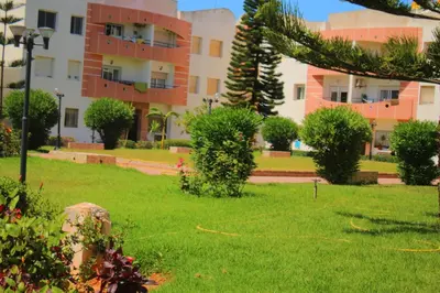 a green yard with a building in the background at MOHAMMEDIA 304 in Mohammedia