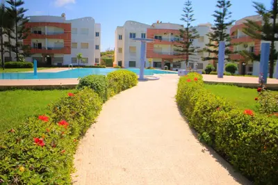 a pathway in front of a building with flowers at MOHAMMEDIA 304 in Mohammedia