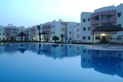 a large swimming pool in front of some buildings at Appartement sable et soleil in Mohammedia