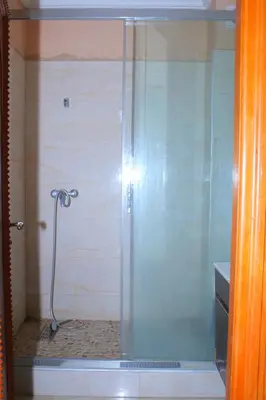 a shower with a glass door in a bathroom at MOHAMMEDIA Residence KAWTAR in Mohammedia