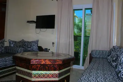 a living room with a couch and a coffee table at MOHAMMEDIA Residence KAWTAR in Mohammedia