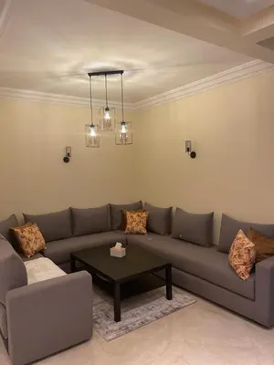 a living room with a couch and a coffee table at CASA BAY BEACH OMK in Sidi Rahal