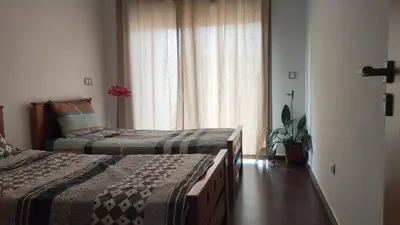 a hotel room with two beds and a window at bouzkina Costa beach golf in Bouznika