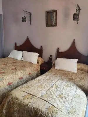 two beds sitting next to each other in a bedroom at HOTEL DU LOUVRE in Casablanca