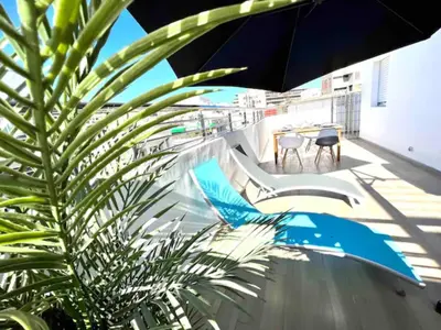 a patio with a table and chairs and an umbrella at Gauthier Living by ShortStayMaroc, Appartement Équipé, Centre, 1 ou 2 Chambres in Casablanca
