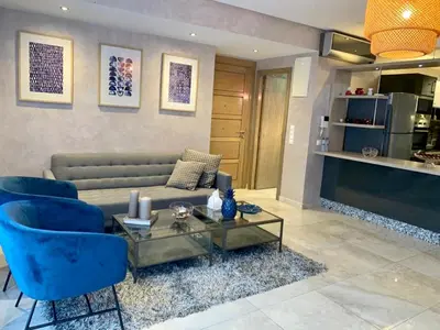 a living room with a couch and chairs and a table at #10 Racine triangle d or near aindiab in Casablanca