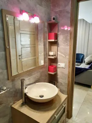 a bathroom with a sink and a mirror at #10 Racine triangle d or near aindiab in Casablanca