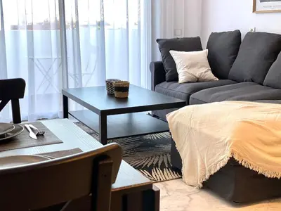 a living room with a couch and a table at Anfa Living 23-BREATHTAKING SEA VIEW NEW&CHIC 5 in Casablanca