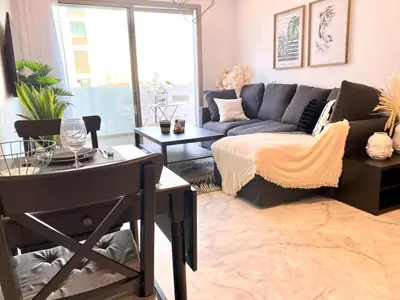 a living room with a couch and a table at Anfa Living 23-BREATHTAKING SEA VIEW NEW&CHIC 5 in Casablanca