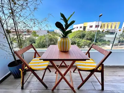 a table and two chairs with a vase on it at ANFA LIVING - Front Sea VIEW 180 -2 or 3 bedrooms- LES TERRASSES D'ANFA by ShortStayMaroc in Casablanca