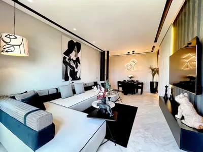 a living room with a couch and a table at ANFA LIVING - Front Sea VIEW 180 -2 or 3 bedrooms- LES TERRASSES D'ANFA by ShortStayMaroc in Casablanca