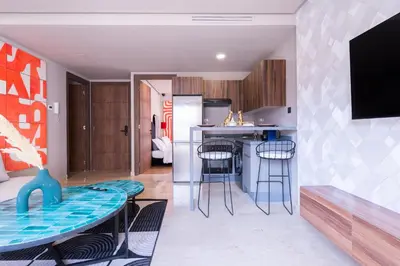 a kitchen and living room with a table and chairs at Luxoria by ShortStayMaroc, Studio Moderne et Chic, Parking, Quartier Central in Casablanca