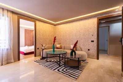 a living room with a couch and a table at Luxoria by ShortStayMaroc, Studio Moderne et Chic, Parking, Quartier Central in Casablanca