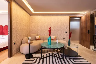 a living room with a couch and a table at Luxoria by ShortStayMaroc, Studio Moderne et Chic, Parking, Quartier Central in Casablanca