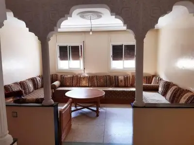 a living room with a couch and a table at Les Appartements de Massira in Temara