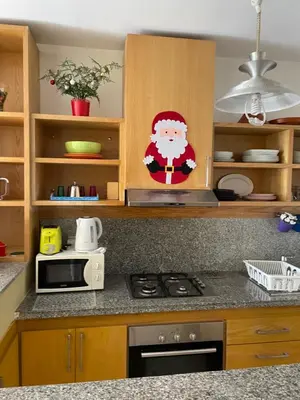 a kitchen with a santa claus sticker on the counter at Airport to Comme à la maison 2 in Derroua