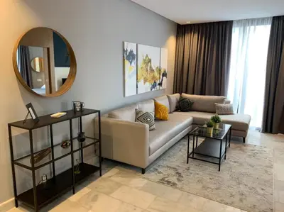 a living room with a couch and a mirror at Luxurious Appart near tramway #fibre optique in Casablanca
