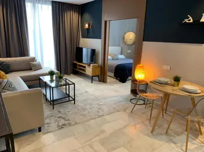 a living room with a couch and a bed and a table at Luxurious Appart near tramway #fibre optique in Casablanca