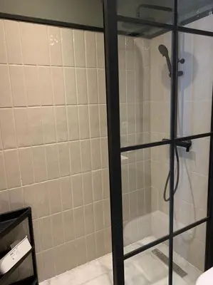 a shower with a glass door in a bathroom at Luxurious Appart near tramway #fibre optique in Casablanca