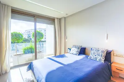 a bedroom with a blue bed and a large window at #13 Fresh Appart in new residence in Casablanca