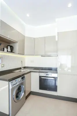 a white kitchen with a dishwasher and a washer at #13 Fresh Appart in new residence in Casablanca