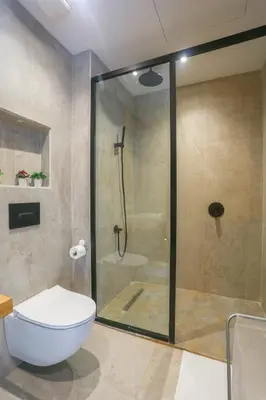 a bathroom with a shower and a white toilet at #34 New Flat in new Garden Residence in Casablanca