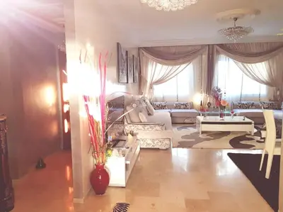 a living room with a couch and a table at Grand Appartement à 5 min de la mer et de la mosqué hassan II de Casablanca in Casablanca