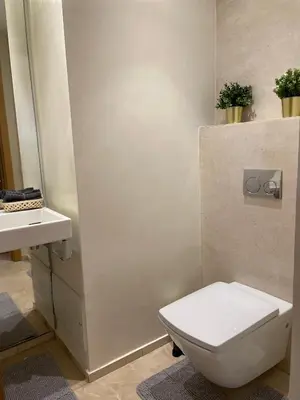 a bathroom with a toilet and a sink at Appartement Anfa Park casa finance City CFC in Casablanca