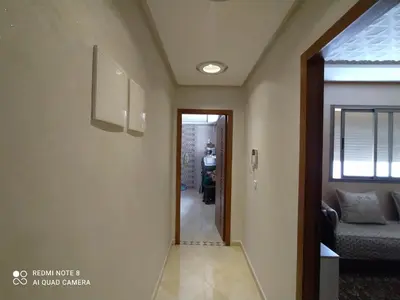 a hallway with a door leading to a living room at Appartement à Bouznika prêt du plage Dahomey, plage bouznika, Bahia beach in Bouznika