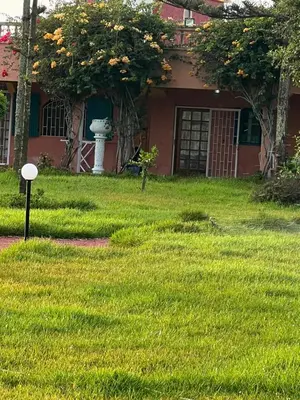 a house with a yard with green grass at Atlantic Vacation villa in Dar Oulad Hajj Kassem