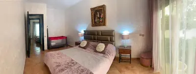 a bedroom with a large bed and a window at Villa avec piscine privée près de Casablanca Maroc in Dar Bouazza
