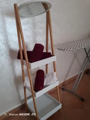a book shelf with a glass top and burgundy pillows at Villa avec piscine privée près de Casablanca Maroc in Dar Bouazza