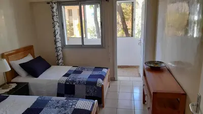 a small room with two beds and a window at Adarissa House in Rabat