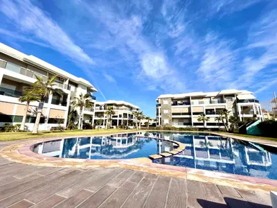 a large swimming pool in front of some buildings at Bel Appartement à AMWAJ Sidi rahal in Casablanca