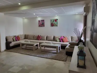 a living room with a couch and two tables at Luxury Spacious Apartment Midtown Casablanca in Casablanca