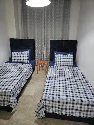 two beds sitting next to each other in a room at Luxury Spacious Apartment Midtown Casablanca in Casablanca
