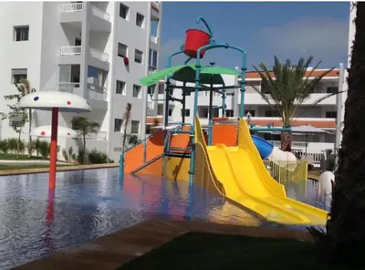 a playground with a slide in a swimming pool at Appartement la Siesta beach resort Mohammedia in Mohammedia